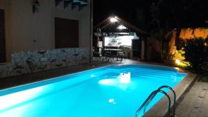 a swimming pool at night with blue lighting at Villa Salvatore in San Leone