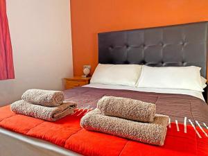 a bed with two pillows on top of it at CASA JAMACO, Corralejo in Corralejo +30 photos