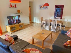 a living room with a couch and a dining room at CASA JAMACO, Corralejo in Corralejo