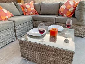 two glasses of wine and a candle on a coffee table at CASA JAMACO, Corralejo in Corralejo