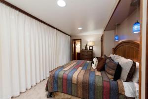a bedroom with a large bed with a striped blanket at Tamarron Gambel Oak 790 - Wild Turkey Ridge - Durango CO in Coffeyville +45 photos
