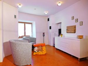 a living room with a table and chairs and a toy at Holiday Home Ferienhaus Döss by Interhome in Müstair
