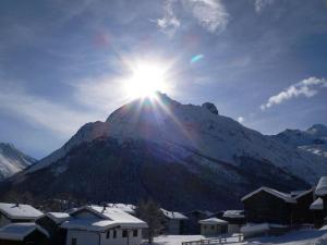 a snow covered mountain with the sun shining on it at Apartment Snow-Fun B by Interhome in Saas-Fee