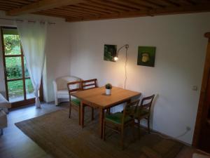 a dining room with a wooden table and chairs at Appartement Waldeck Perle in Hauzenberg