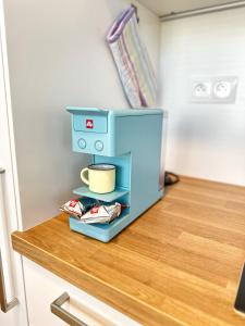 a blue coffee maker sitting on top of a counter at CITY Apartment II in Trenčín