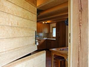 - une cuisine avec des murs en bois et une table en bois dans l'établissement Holiday Home Rustico Vista Adula by Interhome, à Olivone