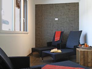 a waiting room with chairs and a table at Apartment B41 by Interhome in Leukerbad +11 photos