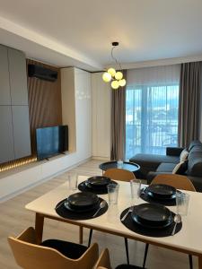 a living room with a table with plates on it at BinderHaus 27 in Sibiu