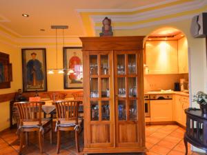 a kitchen and dining room with a table and chairs at Holiday Home Kirchhaus by Interhome in Groß Zicker +23 photos
