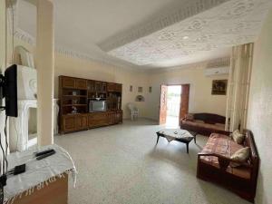 a large living room with a couch and a table at Apartment with amazing view in Bizerte