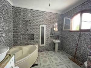 a bathroom with a tub and a sink at Apartment with amazing view in Bizerte