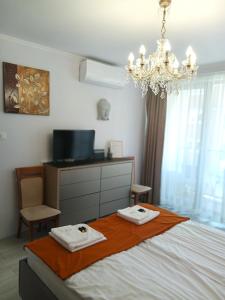 a bedroom with a bed with two towels on it at Planet Gdansk Apartments Mercure Old Nova in Gdańsk