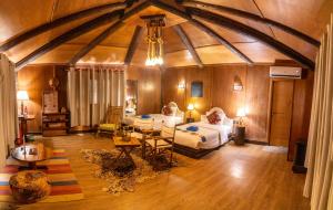 a large room with two beds and a table at Souly Ecolodge Salalah in Salalah