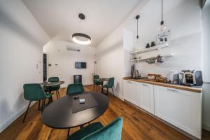 a kitchen and dining room with a table and chairs at Palazzo “Di Palma” Bed & Breakfast in Monte SantʼAngelo