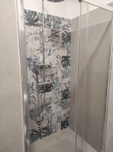 a shower with a glass door in a bathroom at a CASA DI PAPY in Lido Conchiglie