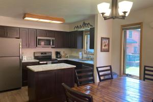 a kitchen with a wooden table and a kitchen with a refrigerator at 515 Cache in Jackson