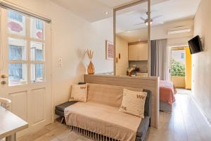 a living room with a couch and a mirror at Lidra Rooms in Chania