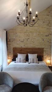 a bedroom with a large bed with a brick wall at La Carte Postale in Oye-Plage +82 photos