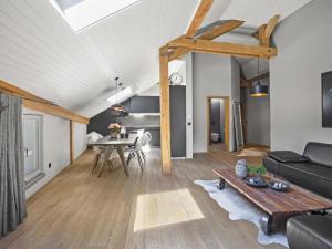 ein Wohnzimmer mit einem Sofa und einem Tisch in der Unterkunft Apartment Honegger by Interhome in Churwalden