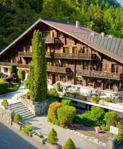 a large wooden building with a large at B & B Hôtel Aux Mille Etoiles in Les Marécottes