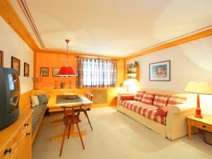 a living room with a couch and a table at Apartment Residenza Chesa Margun 57-4 by Interhome in Surlej