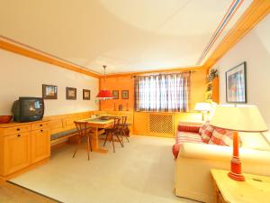a living room with a couch and a table at Apartment Residenza Chesa Margun 57-4 by Interhome in Surlej