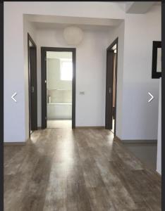 an empty room with white walls and wooden floors at 4 RENT-Apt 3 camere Tichete,Factură in Constanţa