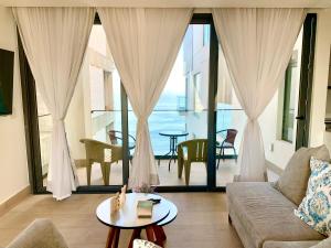 a living room with a couch and a table at Ocean View Condo in Mazatlán