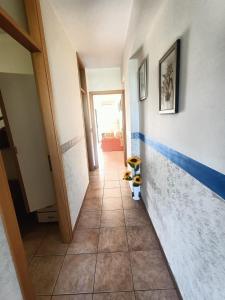 a hallway with blue and white stripes on the wall at Apartment Girasole in Acquedolci +7 photos