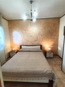 a bedroom with a large bed with two night stands at Apartment Girasole in Acquedolci