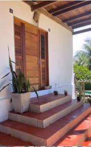 a house with stairs leading to a door at Ville Sweet Home in Canoa Quebrada