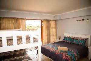 Cama o camas de una habitación en Muzuri Apartment