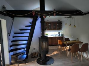 a spiral staircase in a room with a table and a kitchen at Vissi Puhkemaja in Vissi