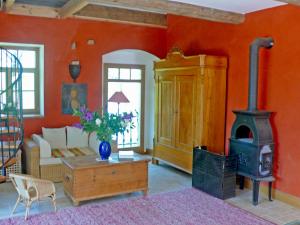 a living room with a couch and a wood stove at Villa Rosencottage by Interhome in Heyda