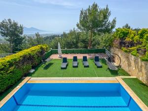 a swimming pool with a lawnarmaarmaarmaarmaarmaarmaarmaarmaarmaarma at Exclusive Villas in Kuşadası
