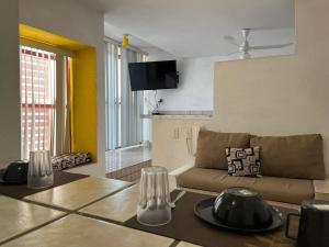 a living room with a couch and a table at INMOTEGA - Suites TG in San Luis Potosí
