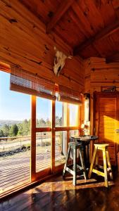 a room with a table and a large window at Fase a Tierra in Atos Pampa