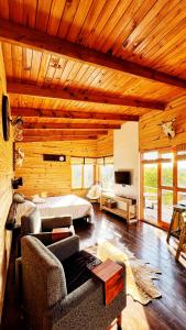 a large bedroom with a bed and a couch at Fase a Tierra in Atos Pampa