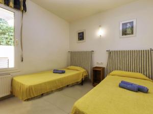 a hotel room with two beds and a window at Holiday Home Mar Nou by Interhome in Llança
