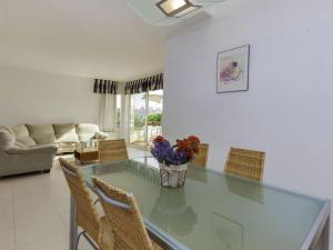 a living room with a glass table and chairs at Holiday Home Mar Nou by Interhome in Llança
