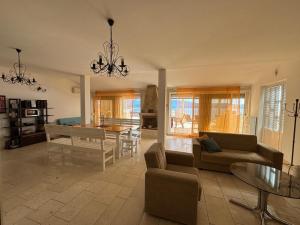 a living room with a couch and a table at Apartment Galeb Komarna in Komarna
