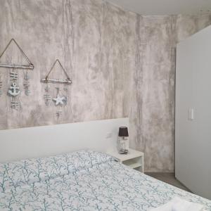 a bedroom with a bed and a table with a night stand at Caletta sul Mare in La Caletta