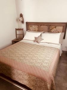 a bedroom with a large bed with a wooden headboard at La Serra Sognante Guest house con giardino in Florence