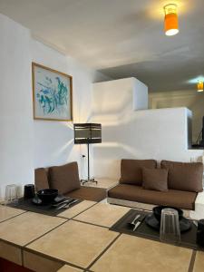 a living room with a couch and a piano at INMOTEGA - Suites TG in San Luis Potosí