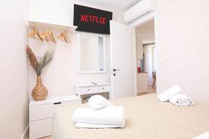 a bedroom with two beds and a sign that reads hello at Patras Luxury Apartment in Corfu Town +36 photos
