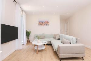 a living room with a couch and a table at Patras Luxury Apartment in Corfu Town