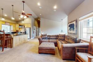 a living room with couches and a kitchen at Woodland Haven in South Lake Tahoe