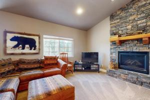 a living room with a fireplace and a television at Woodland Haven in South Lake Tahoe