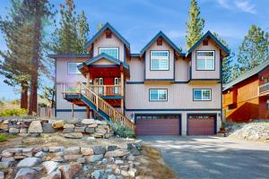 a large house with a garage and a driveway at Woodland Haven in South Lake Tahoe
