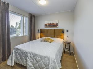 a bedroom with a white bed and a window at Holiday Home Levistar vi as- 6108 by Interhome in Levi